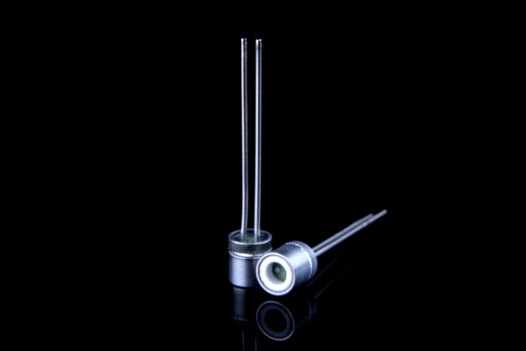 Pyrotechnical header, extreme fine surface finish and accurate flatness, by ceramic lapping. Nickel plating ready for laser/spot welding. Laser welded tube and extra ceramic insulator ring.